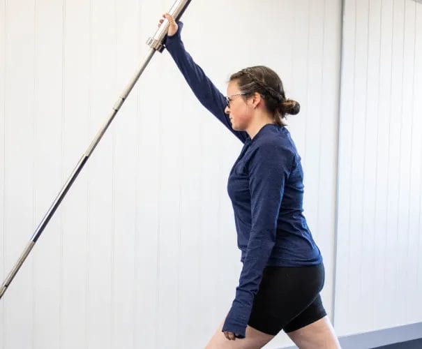Woman exercising with a barbell bar